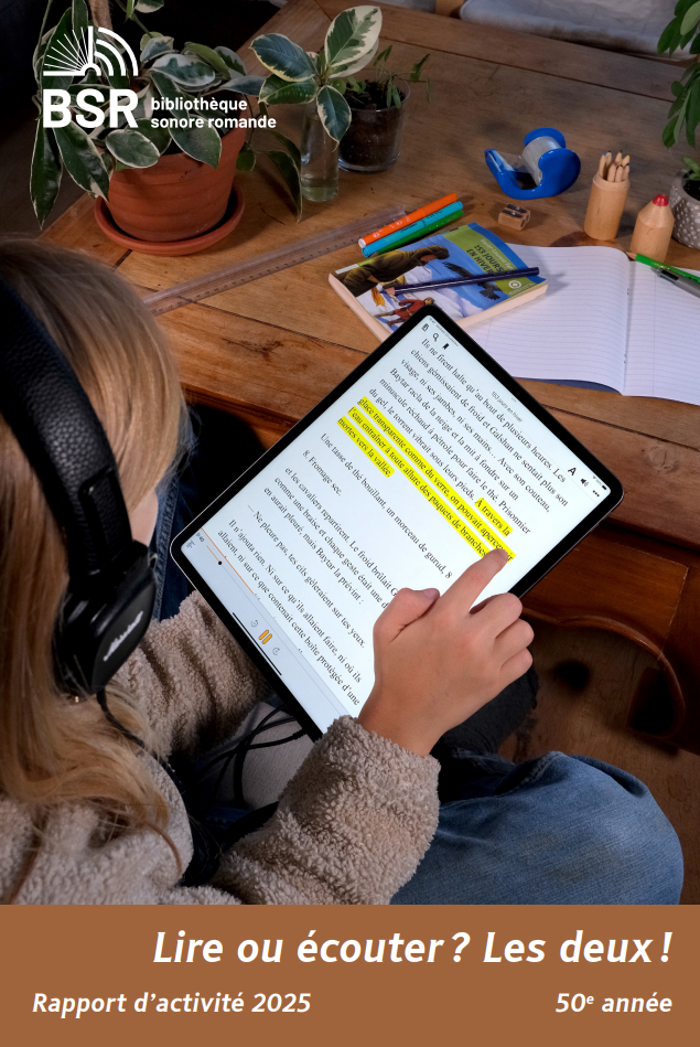 Couverture du rapport annuel 2025 : un écolier écoute un livre audio-texte sur sa tablette, tout en suivant avec son doigt le texte automatiquement mis en évidence au fur et à mesure de la lecture